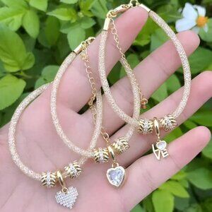 Duo of silver and gold bracelets, gold plated.